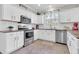 Updated kitchen with stainless steel appliances, white cabinetry, and modern fixtures at 3029 E Patrick St, Gilbert, AZ 85295