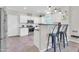 Open kitchen area with stainless steel appliances, bar seating, and tile flooring at 3029 E Patrick St, Gilbert, AZ 85295