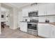 Well-equipped kitchen features stainless steel appliances, white cabinetry, and warm countertops at 3029 E Patrick St, Gilbert, AZ 85295
