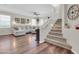 Inviting living room featuring a plush sectional sofa, hardwood floors, and an adjacent staircase at 3029 E Patrick St, Gilbert, AZ 85295