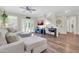 Cozy living space with wood floors, a ceiling fan, a comfortable sofa and an entertainment center at 3029 E Patrick St, Gilbert, AZ 85295