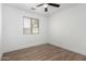 Bedroom features wood-look floors, a ceiling fan, and window at 3528 W Paseo Way, Laveen, AZ 85339