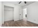 Bedroom features wood-look floors, closet, and a ceiling fan at 3528 W Paseo Way, Laveen, AZ 85339