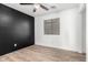 Cozy bedroom with a shiplap accent wall and light wood flooring at 3528 W Paseo Way, Laveen, AZ 85339
