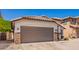 Single-story home with front yard and brown garage door at 3528 W Paseo Way, Laveen, AZ 85339