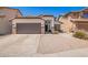 Charming single-story home featuring a brown garage door and decorative stone accents at 3528 W Paseo Way, Laveen, AZ 85339