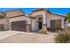 Charming single-story home featuring a brown garage door and decorative stone accents at 3528 W Paseo Way, Laveen, AZ 85339