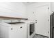 Convenient laundry room with modern machines and stylish tile floor at 3528 W Paseo Way, Laveen, AZ 85339