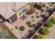 Aerial view of a private backyard oasis with a covered patio and landscaped garden at 36042 N Desert Tea Dr, Queen Creek, AZ 85140