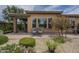 Beautiful backyard with colorful landscaping, paved patio, and charming seating area at 36042 N Desert Tea Dr, Queen Creek, AZ 85140