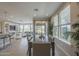 Open-concept dining room with large windows, neutral decor, and stylish table setting at 36042 N Desert Tea Dr, Queen Creek, AZ 85140