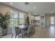 Inviting dining room with large windows, tiled floor, and convenient access to the kitchen area at 36042 N Desert Tea Dr, Queen Creek, AZ 85140