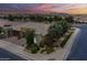 Twilight aerial shot of the property showcasing desert landscaping, mountain views, and neighborhood at 36042 N Desert Tea Dr, Queen Creek, AZ 85140