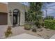 Charming front entrance with desert landscaping and a well lit address above an arched doorway at 36042 N Desert Tea Dr, Queen Creek, AZ 85140