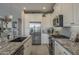 Gourmet kitchen featuring stainless steel appliances, granite counters, and custom cabinetry at 36042 N Desert Tea Dr, Queen Creek, AZ 85140