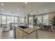 Bright, open kitchen with an island, stainless steel appliances, and access to the dining area at 36042 N Desert Tea Dr, Queen Creek, AZ 85140