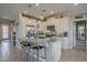 Bright kitchen features stainless steel appliances, granite countertops, pendant lighting, and tiled floors at 36042 N Desert Tea Dr, Queen Creek, AZ 85140