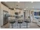 Beautiful kitchen with granite countertops, stainless steel appliances, and a breakfast bar at 36042 N Desert Tea Dr, Queen Creek, AZ 85140