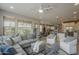 Open living space with a large sectional, kitchen access, and a bright dining area at 36042 N Desert Tea Dr, Queen Creek, AZ 85140