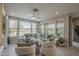 Bright living room featuring a large sectional sofa, ceiling fan, and an abundance of natural light at 36042 N Desert Tea Dr, Queen Creek, AZ 85140