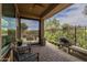 Covered brick patio with built in outdoor kitchen and seating area perfect for entertaining at 36042 N Desert Tea Dr, Queen Creek, AZ 85140