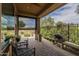 Covered brick patio with built in outdoor kitchen and seating area perfect for entertaining at 36042 N Desert Tea Dr, Queen Creek, AZ 85140