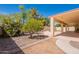 Lush backyard with desert landscaping, a covered patio, and serene views for outdoor living at 3665 E Thames Way, San Tan Valley, AZ 85140