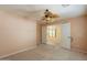 Bedroom with ceiling fan, neutral carpet, and an open doorway at 3665 E Thames Way, San Tan Valley, AZ 85140