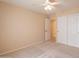 Bright carpeted bedroom with ceiling fan, access to bathroom, and closet for extra storage at 3665 E Thames Way, San Tan Valley, AZ 85140