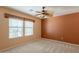 Bright bedroom with a ceiling fan, window blinds, and neutral carpeting at 3665 E Thames Way, San Tan Valley, AZ 85140