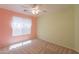 Cozy bedroom with bright walls, a ceiling fan, and a window providing ample natural light at 3665 E Thames Way, San Tan Valley, AZ 85140