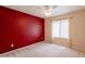 Well-lit bedroom with soft carpet, ceiling fan, and a large window offering great natural light at 3665 E Thames Way, San Tan Valley, AZ 85140