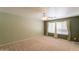 Comfortable bedroom with ceiling fan and neutral carpet near large windows at 3665 E Thames Way, San Tan Valley, AZ 85140