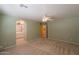 Bright bedroom with ceiling fan and natural light leads to the bathroom at 3665 E Thames Way, San Tan Valley, AZ 85140