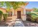 Inviting front entrance with a charming archway, beautiful landscaping and an attractive front door at 3665 E Thames Way, San Tan Valley, AZ 85140