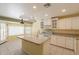 Spacious kitchen with white cabinets, an island with sink, and an adjacent dining area at 3665 E Thames Way, San Tan Valley, AZ 85140