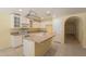 Well-lit kitchen featuring white cabinets, tile flooring, and an open layout at 3665 E Thames Way, San Tan Valley, AZ 85140