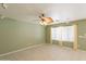 Inviting living room with ceiling fan and natural light from large windows at 3665 E Thames Way, San Tan Valley, AZ 85140