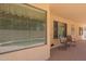 A covered patio with chairs, offering a relaxing outdoor space with shade and ventilation at 3665 E Thames Way, San Tan Valley, AZ 85140