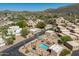 Aerial view showcasing a private pool, desert landscaping, and Southwestern-style homes at 38065 N Cave Creek Rd # 52, Cave Creek, AZ 85331