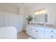 Bathroom highlighting a vanity with granite countertops, white cabinets, and a tub at 38065 N Cave Creek Rd # 52, Cave Creek, AZ 85331