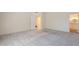 Bright bedroom featuring neutral walls, carpeted floors, and an ensuite bathroom entrance at 38065 N Cave Creek Rd # 52, Cave Creek, AZ 85331