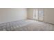 Inviting bedroom with plush gray carpeting, neutral walls, and a private patio entrance through shuttered glass doors at 38065 N Cave Creek Rd # 52, Cave Creek, AZ 85331