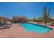 Relax by the community pool with lounge chairs, mature cactus, and serene desert landscape views at 38065 N Cave Creek Rd # 52, Cave Creek, AZ 85331