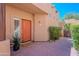 Charming front entrance with a vibrant orange door, stylish accents, and desert landscaping at 38065 N Cave Creek Rd # 52, Cave Creek, AZ 85331