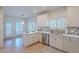 Bright kitchen featuring white cabinets, stainless steel appliances, modern backsplash, and convenient breakfast bar with pendant lighting at 38065 N Cave Creek Rd # 52, Cave Creek, AZ 85331
