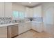 Well-lit kitchen featuring a stainless steel dishwasher and ample white cabinet space at 38065 N Cave Creek Rd # 52, Cave Creek, AZ 85331