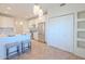 Charming kitchen boasting white cabinets, stainless steel fridge, breakfast bar seating, and tiled flooring for a welcoming space at 38065 N Cave Creek Rd # 52, Cave Creek, AZ 85331