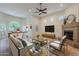 Bright living room features a fireplace, ceiling fan, tile floors, and an adjacent dining area with a large window at 38065 N Cave Creek Rd # 52, Cave Creek, AZ 85331