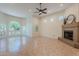 Spacious living room with fireplace, large arched window, and tile flooring, offering a versatile and comfortable living space at 38065 N Cave Creek Rd # 52, Cave Creek, AZ 85331